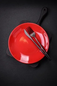 Bumpy empty ceramic plate on a textured concrete background 写真素材