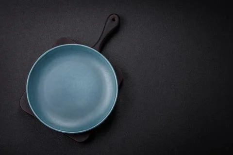 Bumpy empty ceramic plate on a textured concrete background 写真素材