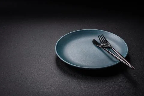 Bumpy empty ceramic plate on a textured concrete background Stock Photos