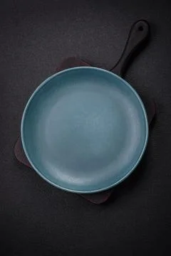 Bumpy empty ceramic plate on a textured concrete background 写真素材