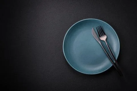 Bumpy empty ceramic plate on a textured concrete background Stock Photos