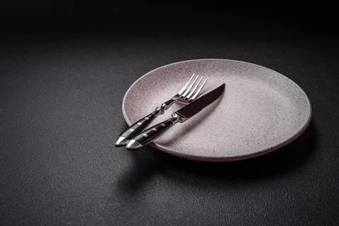 Bumpy empty ceramic plate on a textured concrete background 写真素材