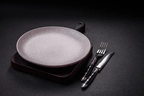 Bumpy empty ceramic plate on a textured concrete background 写真素材