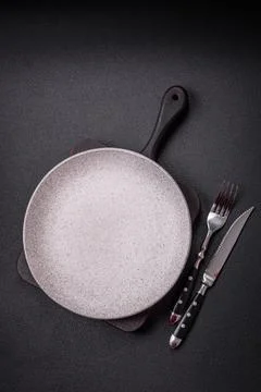 Bumpy empty ceramic plate on a textured concrete background Stock Photos