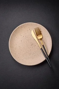 Bumpy empty ceramic plate on a textured concrete background Stock Photos