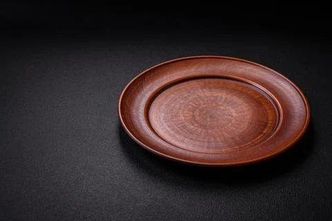 Bumpy empty ceramic plate on a textured concrete background 写真素材