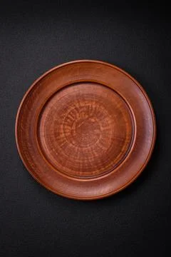 Bumpy empty ceramic plate on a textured concrete background 写真素材