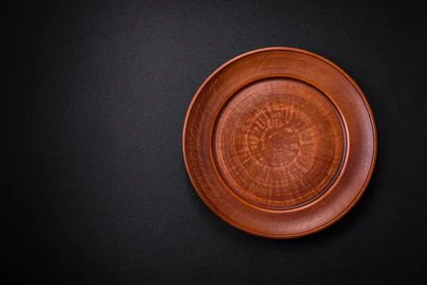 Bumpy empty ceramic plate on a textured concrete background Stock Photos