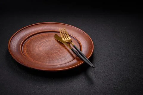 Bumpy empty ceramic plate on a textured concrete background Stock Photos