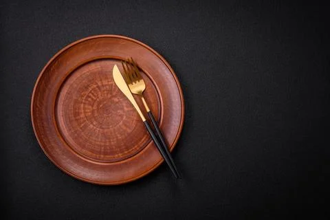 Bumpy empty ceramic plate on a textured concrete background 写真素材