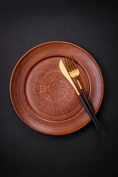Bumpy empty ceramic plate on a textured concrete background Stock Photos