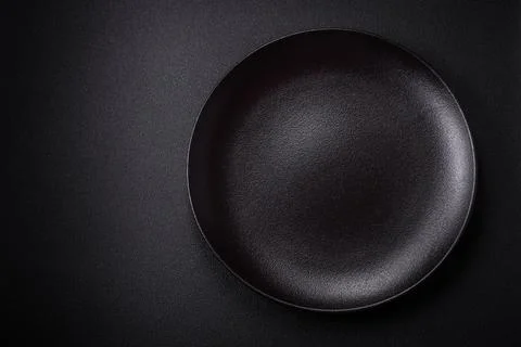 Bumpy empty ceramic plate on a textured concrete background Stock Photos