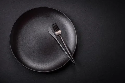 Bumpy empty ceramic plate on a textured concrete background Stock Photos