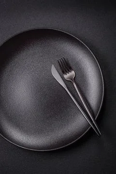 Bumpy empty ceramic plate on a textured concrete background 写真素材