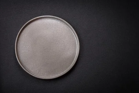 Bumpy empty ceramic plate on a textured concrete background Stock Photos