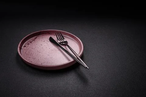 Bumpy empty ceramic plate on a textured concrete background Stock Photos
