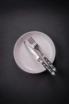 Bumpy empty ceramic plate on a textured concrete background Stock Photos