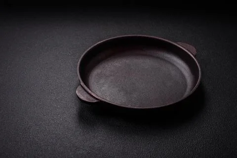 Bumpy empty ceramic plate on a textured concrete background 写真素材