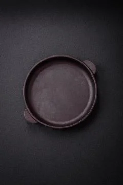 Bumpy empty ceramic plate on a textured concrete background Stock Photos