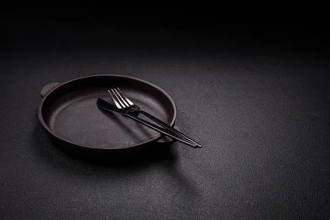 Bumpy empty ceramic plate on a textured concrete background 스톡 사진