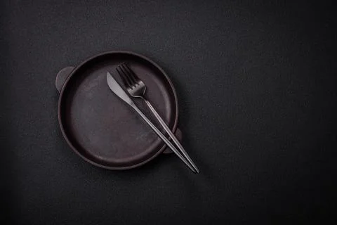 Bumpy empty ceramic plate on a textured concrete background Stock Photos