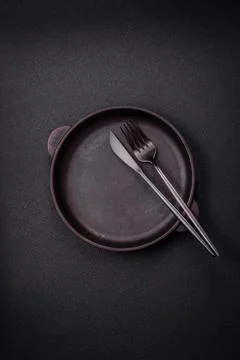 Bumpy empty ceramic plate on a textured concrete background 写真素材