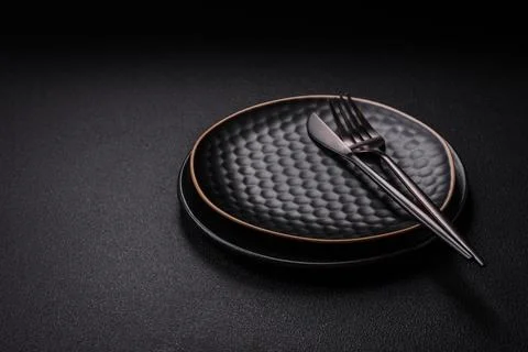 Bumpy empty ceramic plate on a textured concrete background Stock Photos