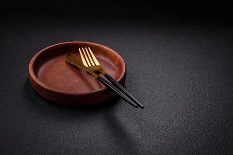 Bumpy empty ceramic plate on a textured concrete background 写真素材