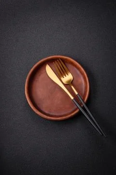 Bumpy empty ceramic plate on a textured concrete background 스톡 사진