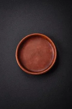 Bumpy empty ceramic plate on a textured concrete background 写真素材