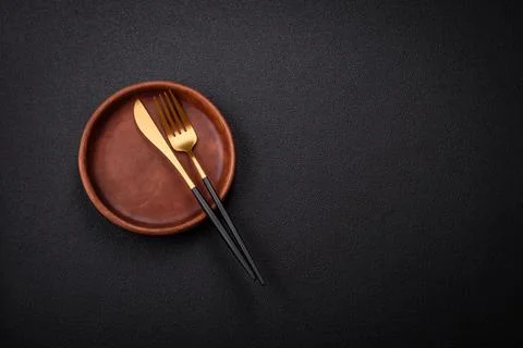 Bumpy empty ceramic plate on a textured concrete background 写真素材