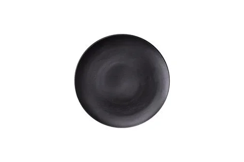 Bumpy empty ceramic plate on a textured concrete background 写真素材