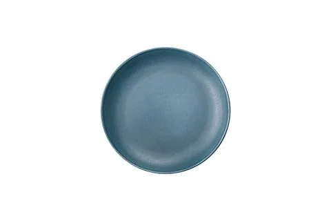 Bumpy empty ceramic plate on a textured concrete background Stock Photos