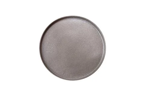 Bumpy empty ceramic plate on a textured concrete background 写真素材