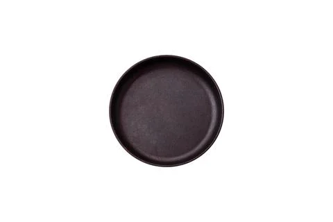 Bumpy empty ceramic plate on a textured concrete background 写真素材