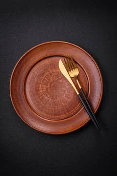 Bumpy empty ceramic plate on a textured concrete background Bumpy empty ce... 写真素材