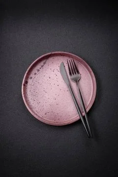 Bumpy empty ceramic plate on a textured concrete background Bumpy empty ce... 写真素材