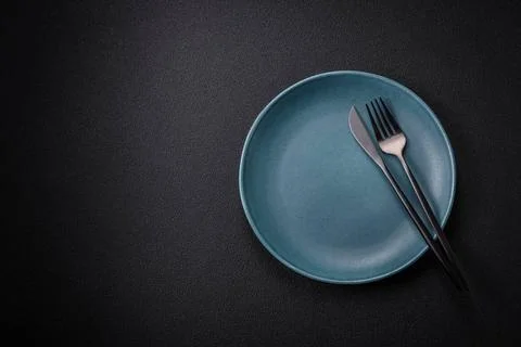 Bumpy empty ceramic plate on a textured concrete background Bumpy empty ce... 写真素材