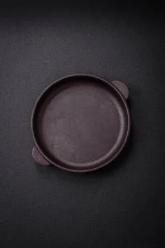 Bumpy empty ceramic plate on a textured concrete background Bumpy empty ce... Stock Photos