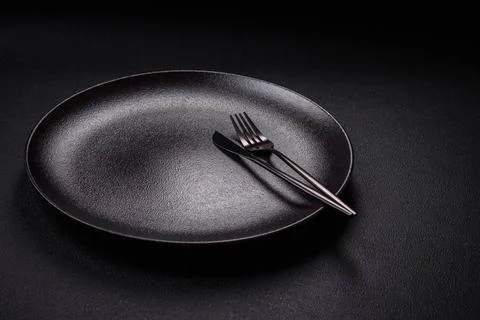 Bumpy empty ceramic plate on a textured concrete background Bumpy empty ce... 写真素材