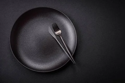 Bumpy empty ceramic plate on a textured concrete background Bumpy empty ce... 写真素材