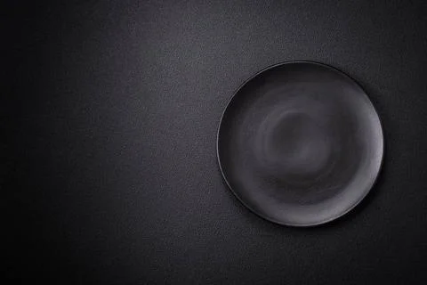 Bumpy empty ceramic plate on a textured concrete background Bumpy empty ce... Stock Photos