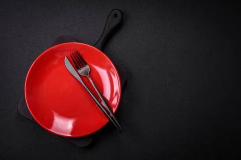 Bumpy empty ceramic plate on a textured concrete background Bumpy empty ce... 写真素材