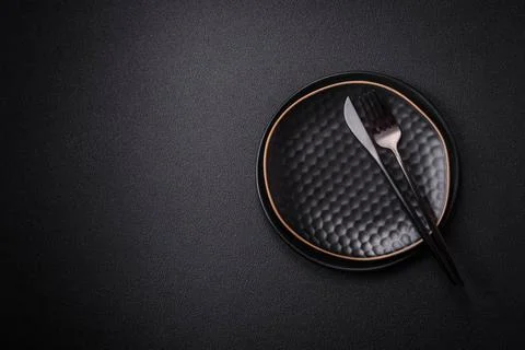 Bumpy empty ceramic plate on a textured concrete background Bumpy empty ce... Stock Photos