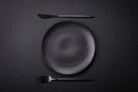 Bumpy empty ceramic plate on a textured concrete background Bumpy empty ce... 写真素材