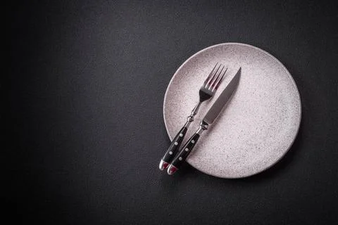 Bumpy empty ceramic plate on a textured concrete background Bumpy empty ce... 写真素材