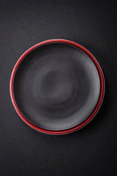 Bumpy empty ceramic plate on a textured concrete background Bumpy empty ce... 写真素材