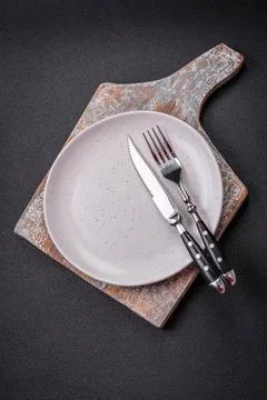 Bumpy empty ceramic plate on a textured concrete background Bumpy empty ce... Stock Photos