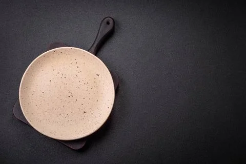 Bumpy empty ceramic plate on a textured concrete background Bumpy empty ce... 写真素材