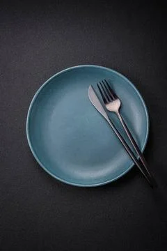 Bumpy empty ceramic plate on a textured concrete background Bumpy empty ce... 写真素材